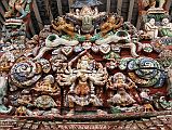 Kathmandu Patan 02-2 Rato Red Machhendranath Temple One Of The Carved Doorways Close Up With Garuda At Top And Figure With Three Heads and Eight Arms Below